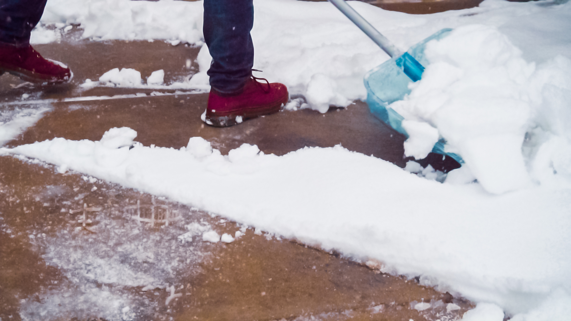Snow shoveling concrete driveway 