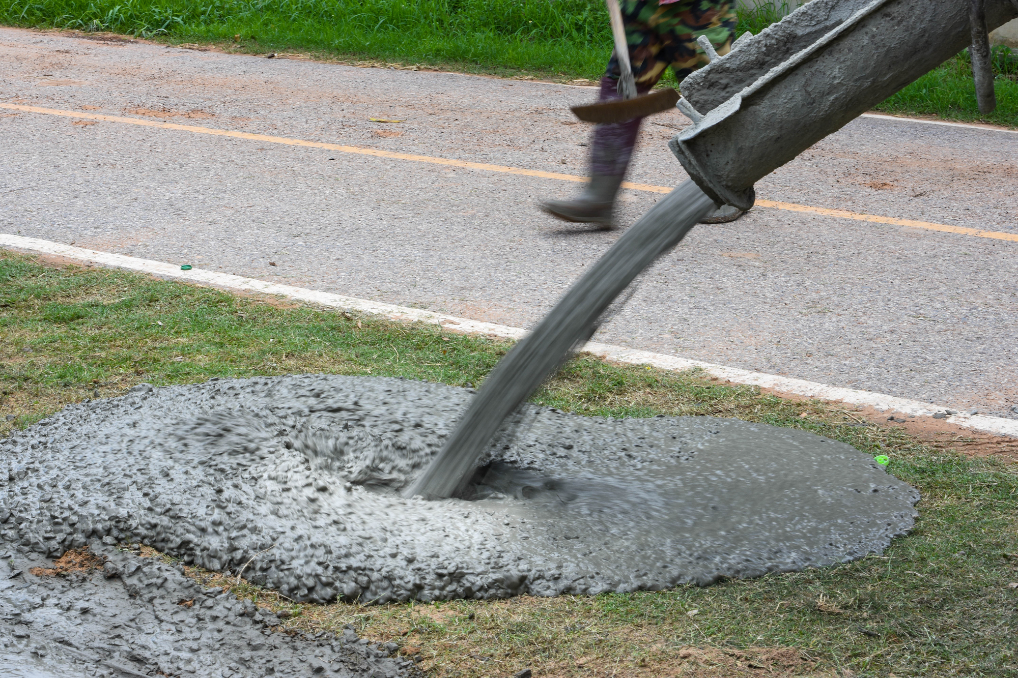 The cement technician is pouring the building floor.