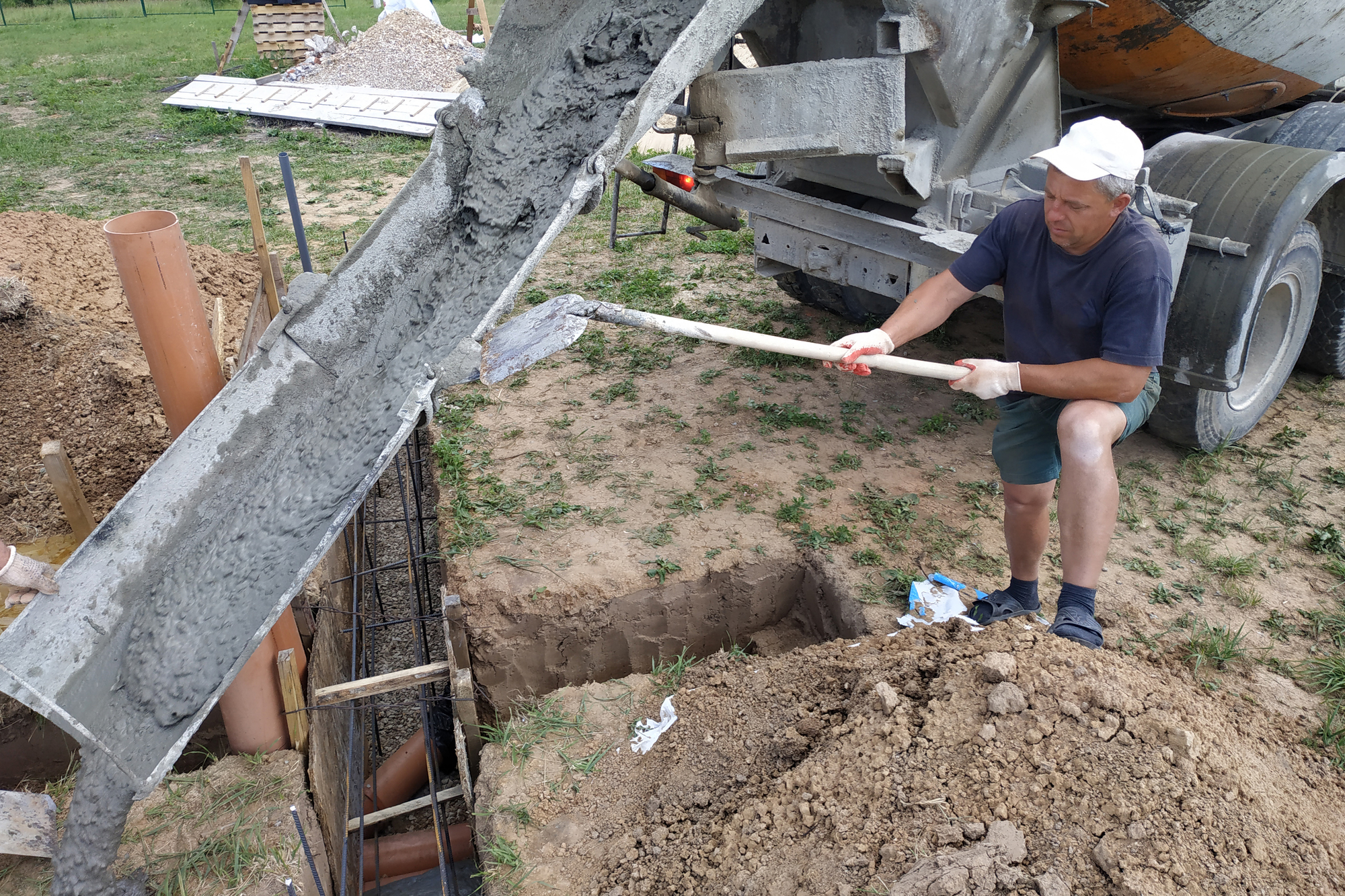Pouring cement into the trench with a mixer