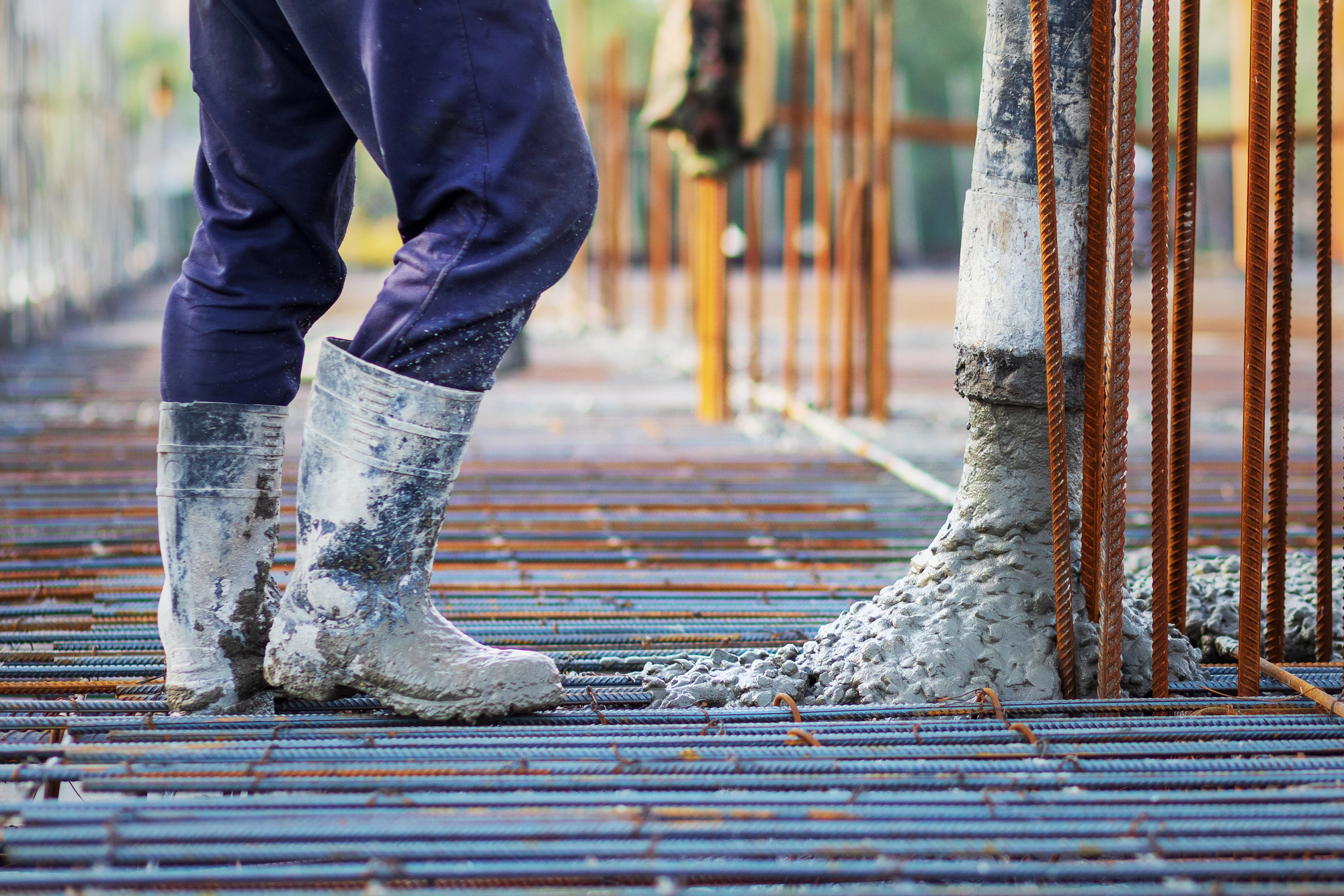 Concrete is poured into a steel reinforcement frame